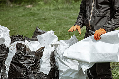 Worker collecting litter wearing a safety vest