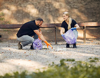 Worker handling recycling container